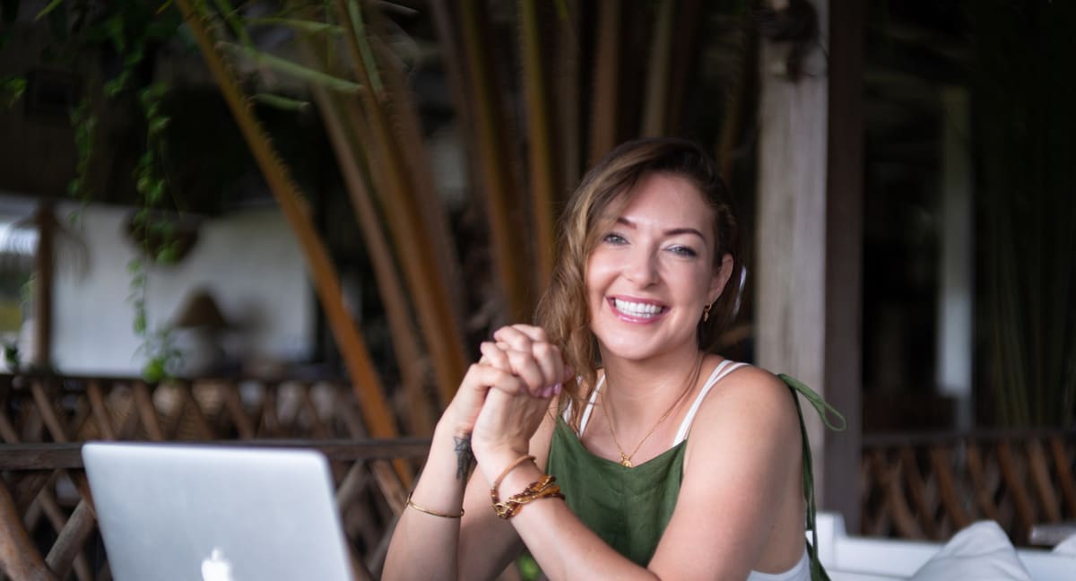 Ashlie Walker smiling at her laptop